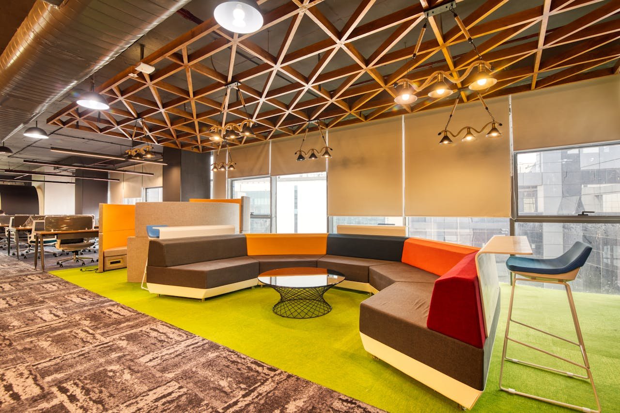 hero-img-01 Vibrant open office space with colorful seating and contemporary design elements.